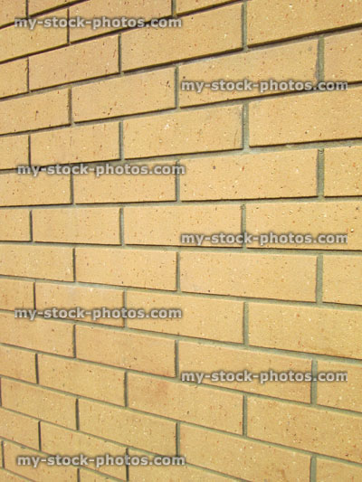 Stock image of modern yellow brick wall of house, looking sideways