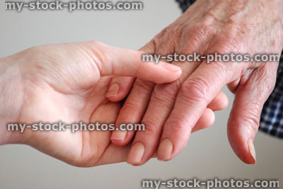 Stock image of holding hands, young and old hands, children / senior, granddaughter / grandmother
